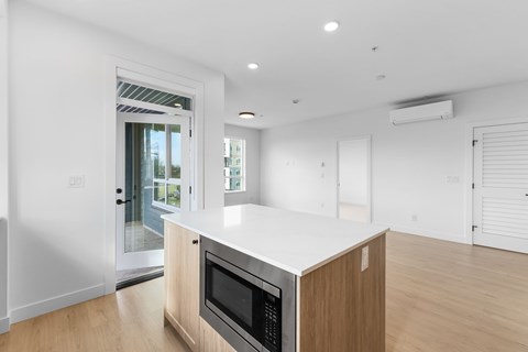 A modern kitchen with a microwave oven built into the countertop.