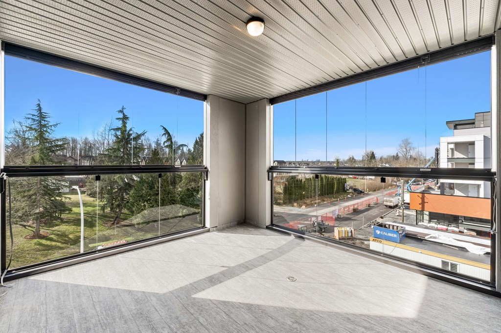 A balcony with a view of a construction site and trees.