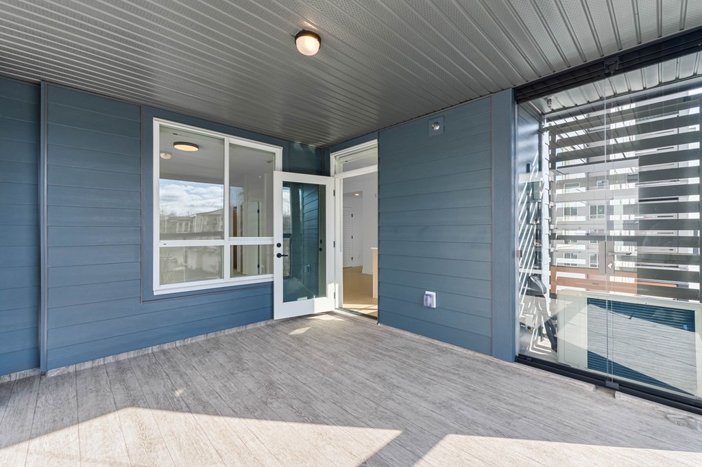 A room with a blue wall and a wooden floor.