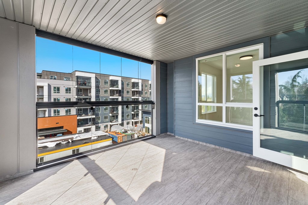 A modern building with a balcony overlooking other buildings.