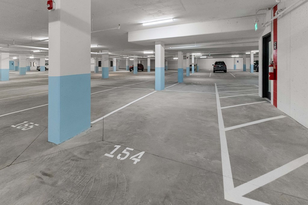 A parking garage with the number 154 painted on the ground.