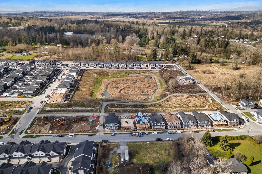 A bird's eye view of a residential area with houses and a construction site.
