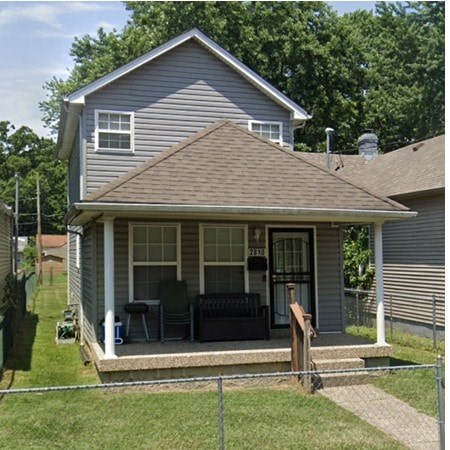 A small house with a porch and a covered patio.