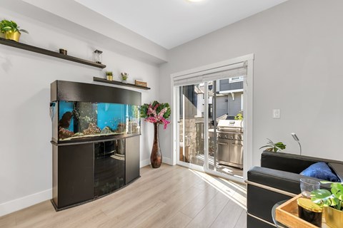 A modern living room with a fish tank and a couch.