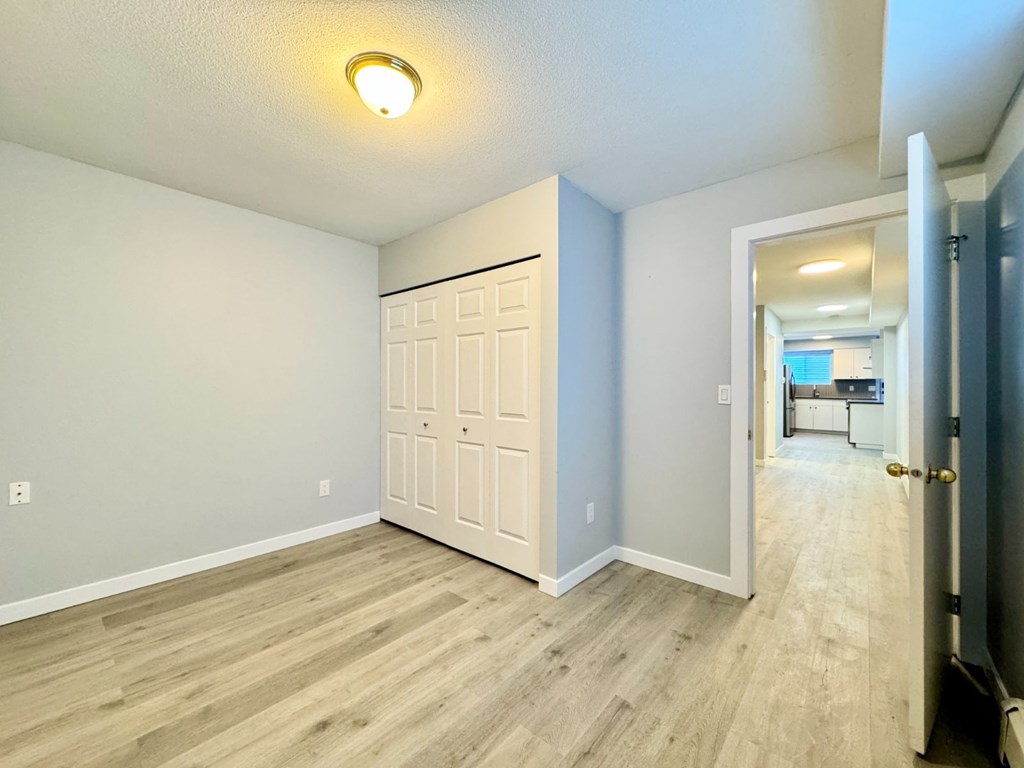 A room with a white door and a light on the ceiling.
