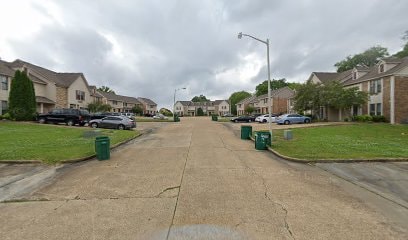 A street view of a residential area with houses on both sides.