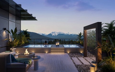 A modern outdoor patio with a hot tub and a view of the mountains.