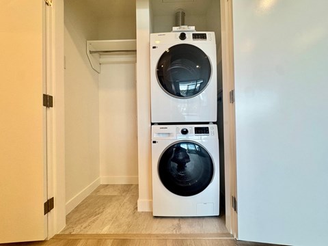 A white washing machine and dryer in a small laundry room.