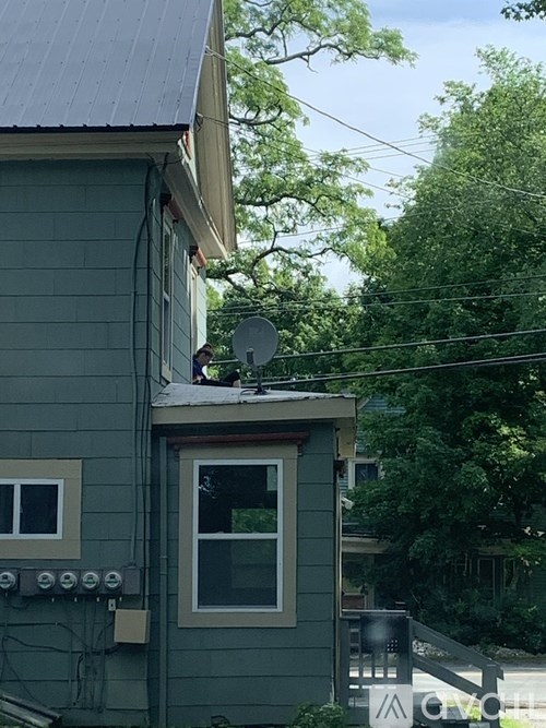 A house with a satellite dish on the roof.
