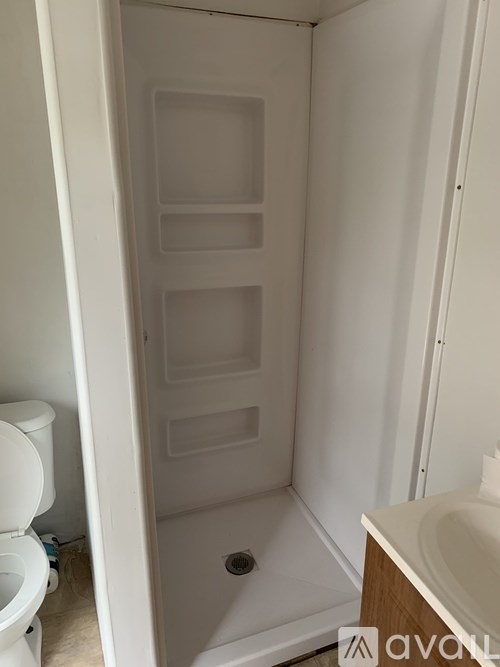 A white bathroom with a toilet and a sink.