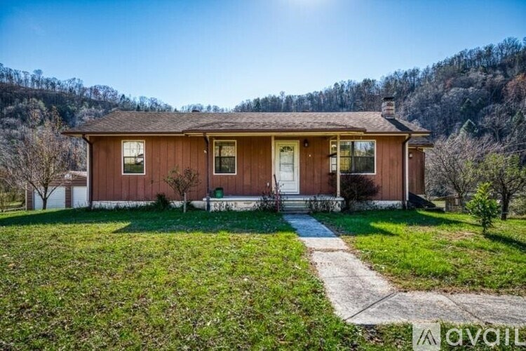 A house with a brown roof and white trim is for sale.