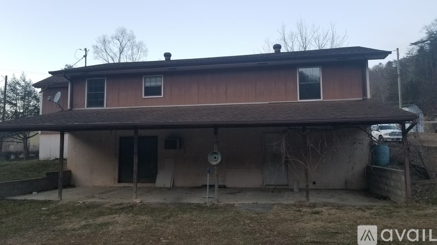 A house with a brown roof and a sign that says "available" in the foreground.