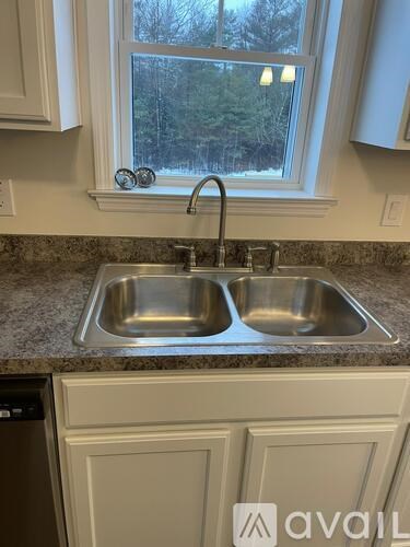 A kitchen sink with a window above it.