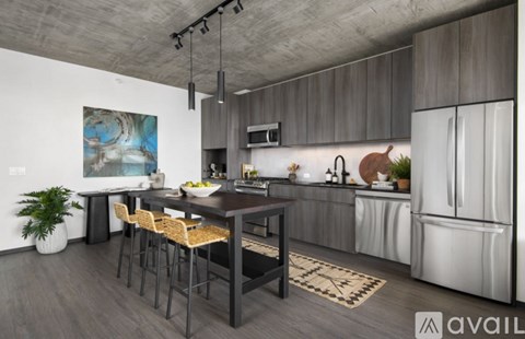 A modern kitchen with a dining table and chairs.