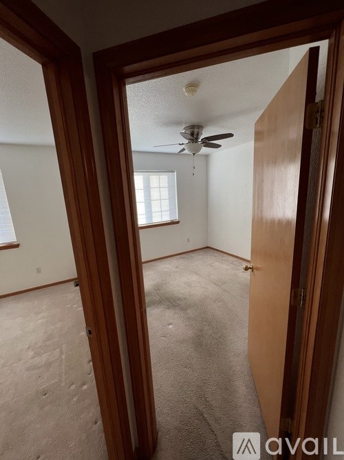 A room with a ceiling fan and a window is available for rent.