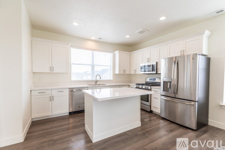 A kitchen with white cabinets and stainless steel appliances.