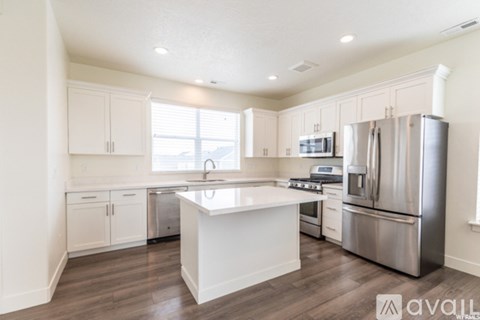 A kitchen with white cabinets and stainless steel appliances.