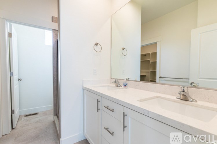 A bathroom with a sink, mirror, and medicine cabinet.