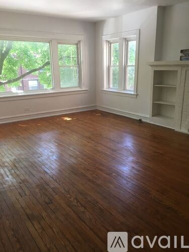 A room with wooden floors and a window.