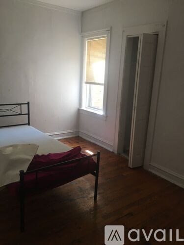 A room with a bed and a window.