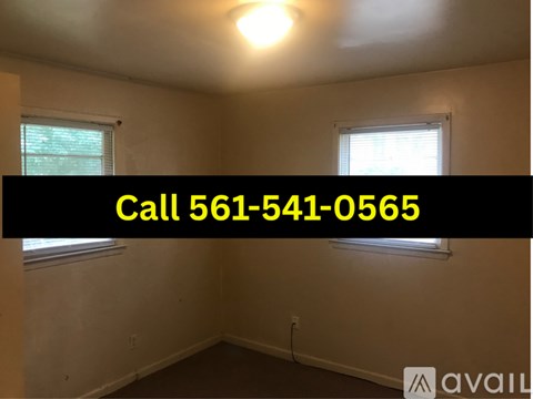 A hallway with a white door and a white cabinet.