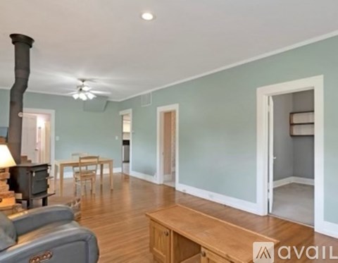 A living room with a grey couch and a wood table.