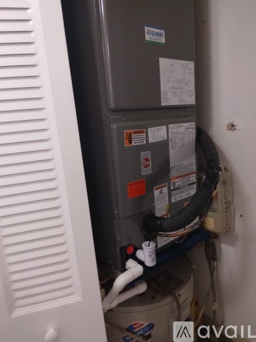 A furnace and air conditioner unit installed in a wall.