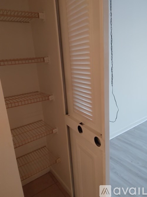 A white door with a chain hanging from it.