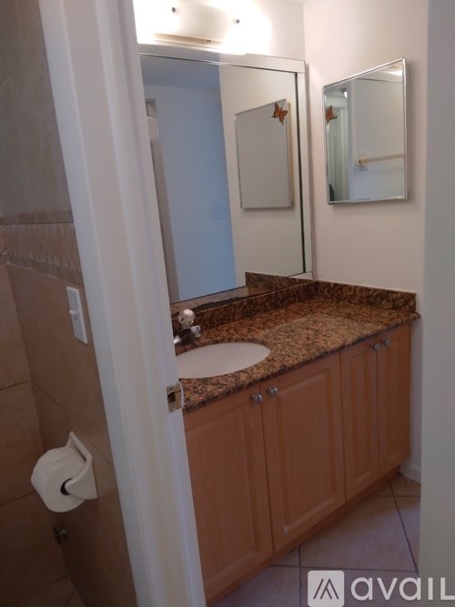 A bathroom with a sink and mirror.