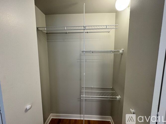 A walk-in closet with shelves and a door.