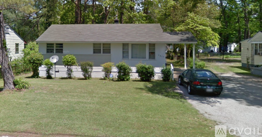 A house with a car parked in front.