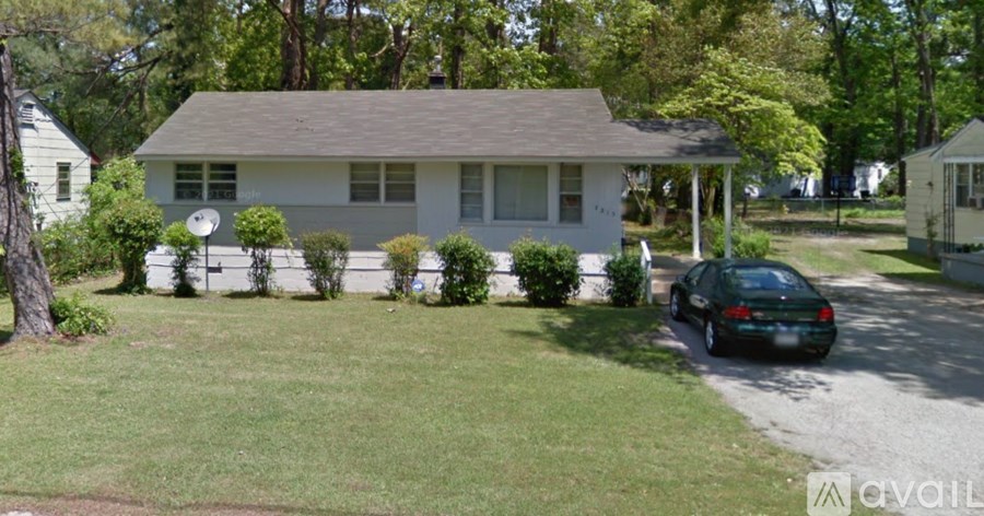 A house with a car parked in front.