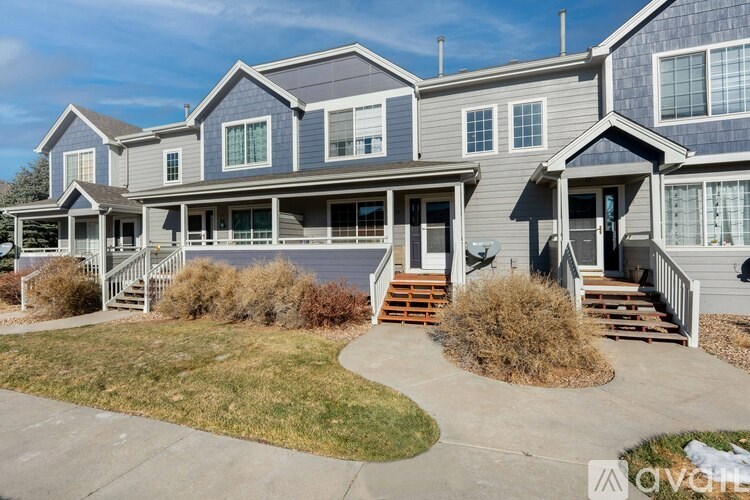 A row of houses with grey and blue siding.