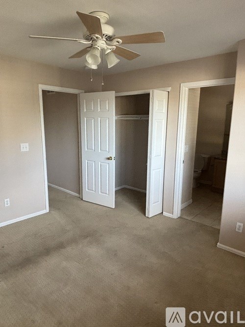 A bathroom with a brown shower curtain and a white toilet.