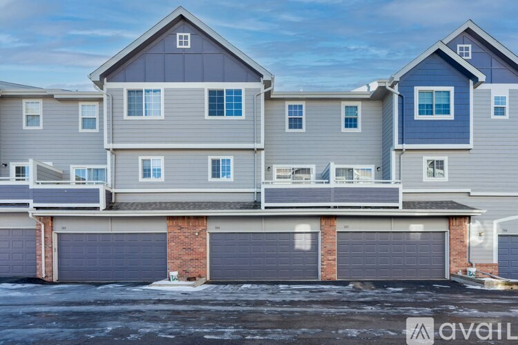 A row of houses with garages in front.