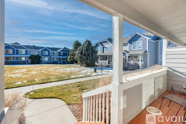 A balcony with a view of a residential area.
