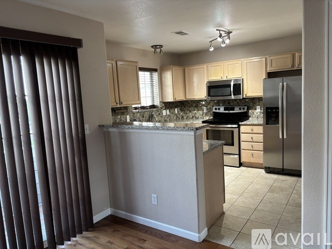 A living room with a wooden floor and a television.