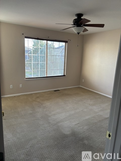 A dining room with a table and chairs.