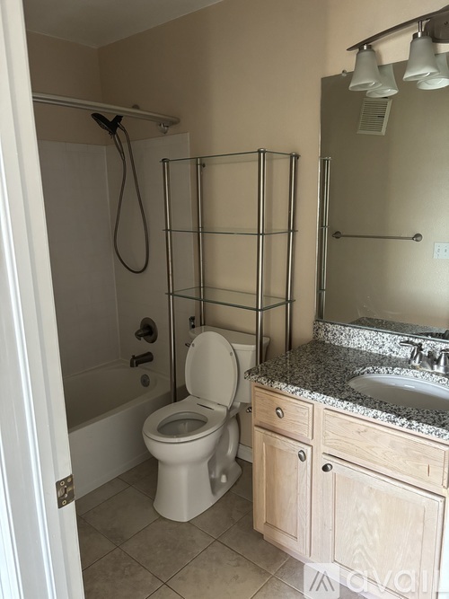 A kitchen with wooden cabinets and granite countertops is available for rent.