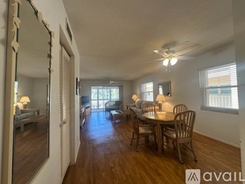A living room with a dining table and chairs.