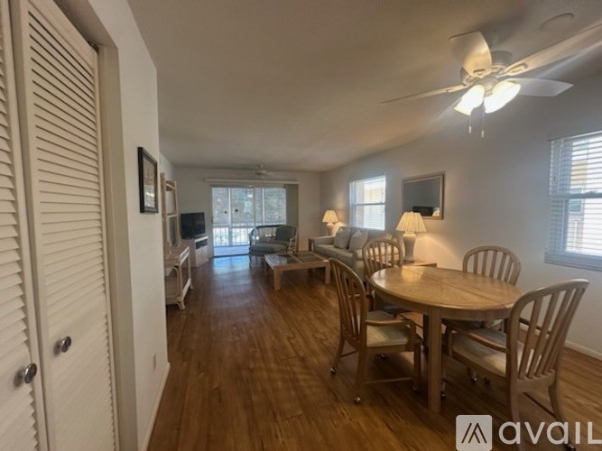A dining room with a wooden table and chairs.