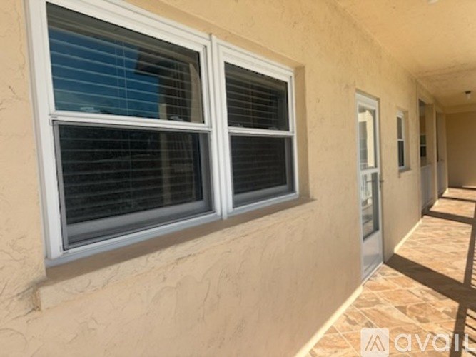 A wall with a window and a door.