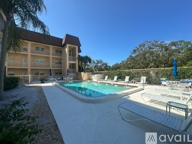 A large building with a pool in front of it.