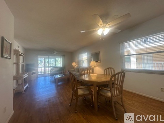 A dining room with a table set for four.