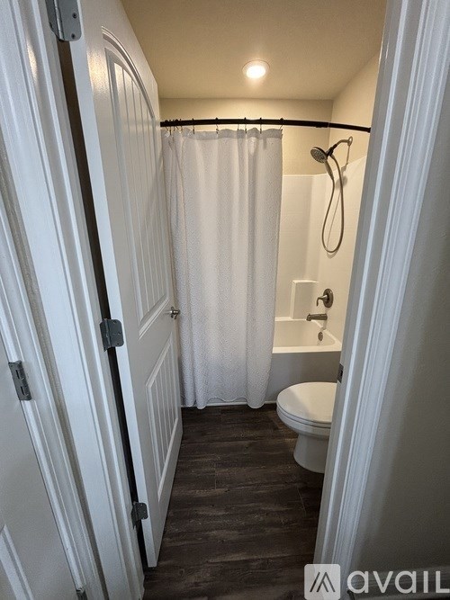 A bathroom with a toilet, sink, and shower.