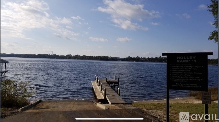 A dock with a sign that says Rolley Camp.