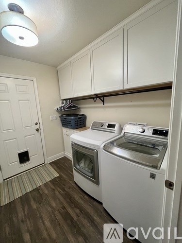 A small laundry room with a washer and dryer.