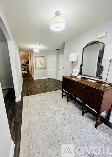 A bedroom with a wooden vanity and a mirror.