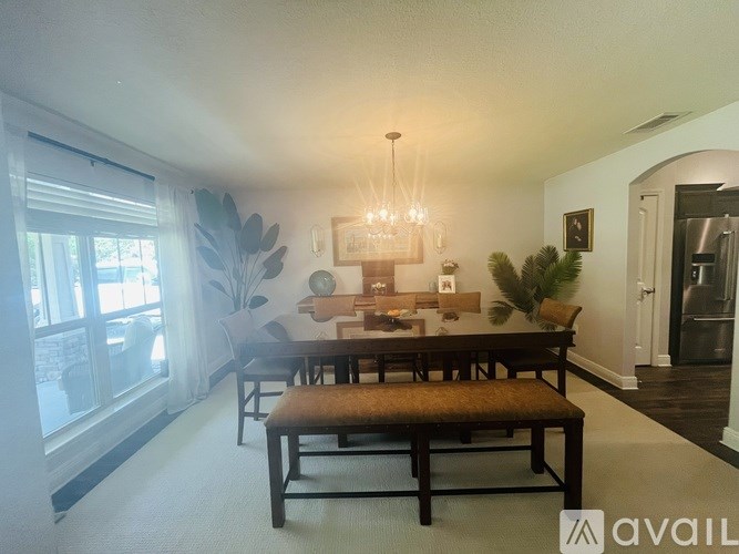 A dining room with a table and chairs.