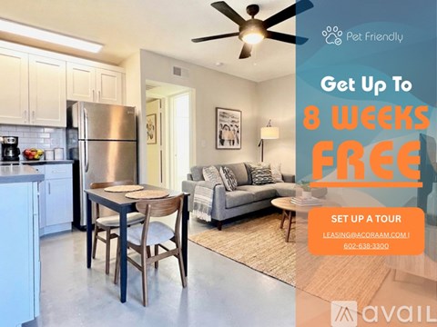 A kitchen with a refrigerator, microwave, and oven.
